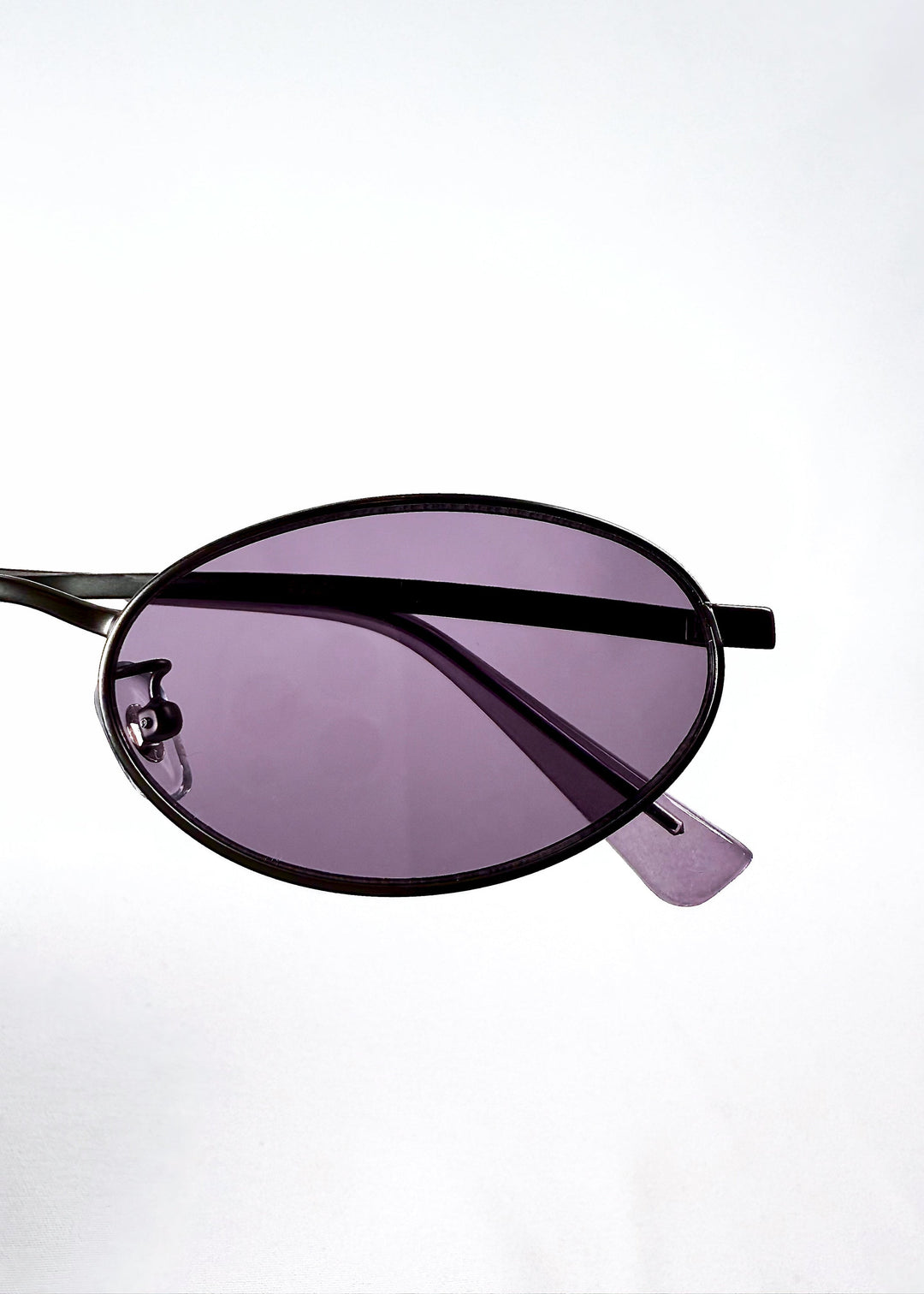 Detailed close-up of Solstice – Gunmetal Frost lens showing vibrant purple tint and lens edge. 