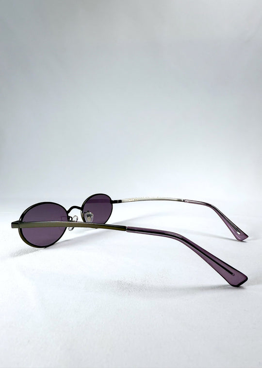 Side view of Solstice – Gunmetal Frost sunglasses highlighting the slim gunmetal arms and purple tips. 
