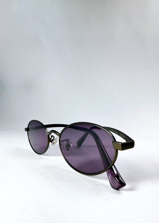 Close-up of Solstice – Gunmetal Frost sunglasses showing the gunmetal hinge and frame detail, highlighting the vibrant purple lens and acetate arm design. 