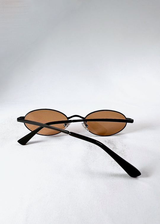 Folded back view of Solstice – Mahogany Black sunglasses showing the structure and smooth matte finish. 