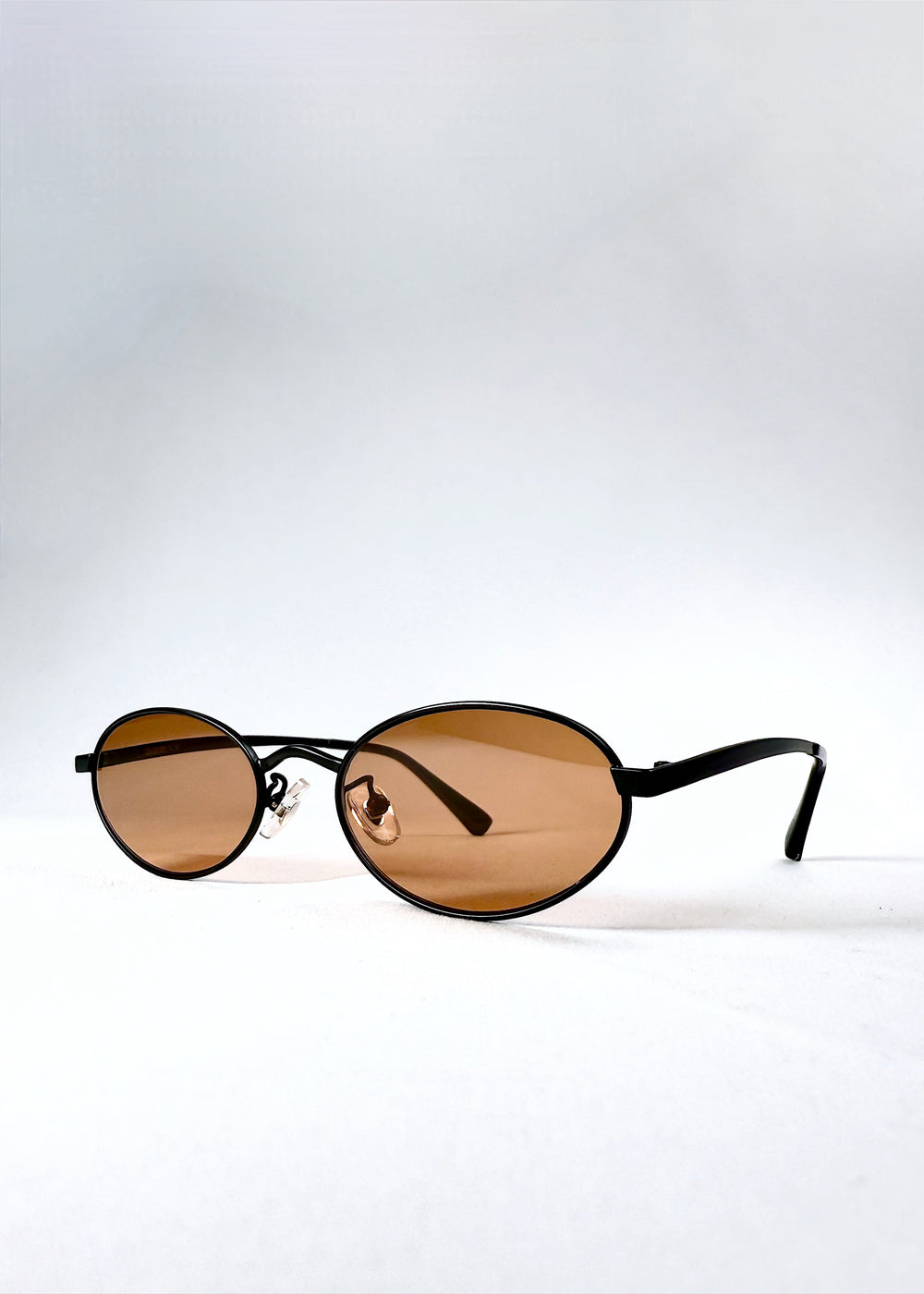 Front-angle view of Solstice – Mahogany Black sunglasses highlighting the satin black frame and deep brown tint.