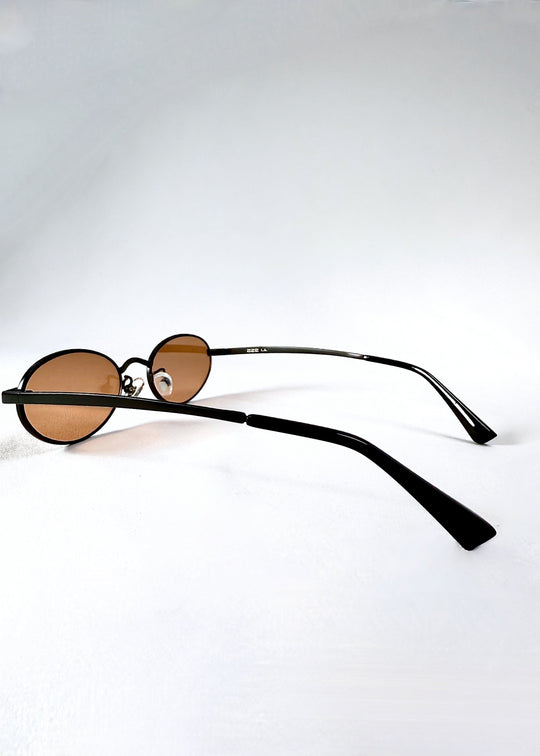Side view of Solstice sunglasses in Mahogany Black featuring slim temples and gently curved arms. 