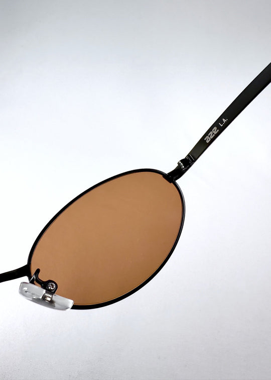 Detail view of the Aze L.A. logo on the temple arm of the Solstice – Mahogany Black sunglasses. 