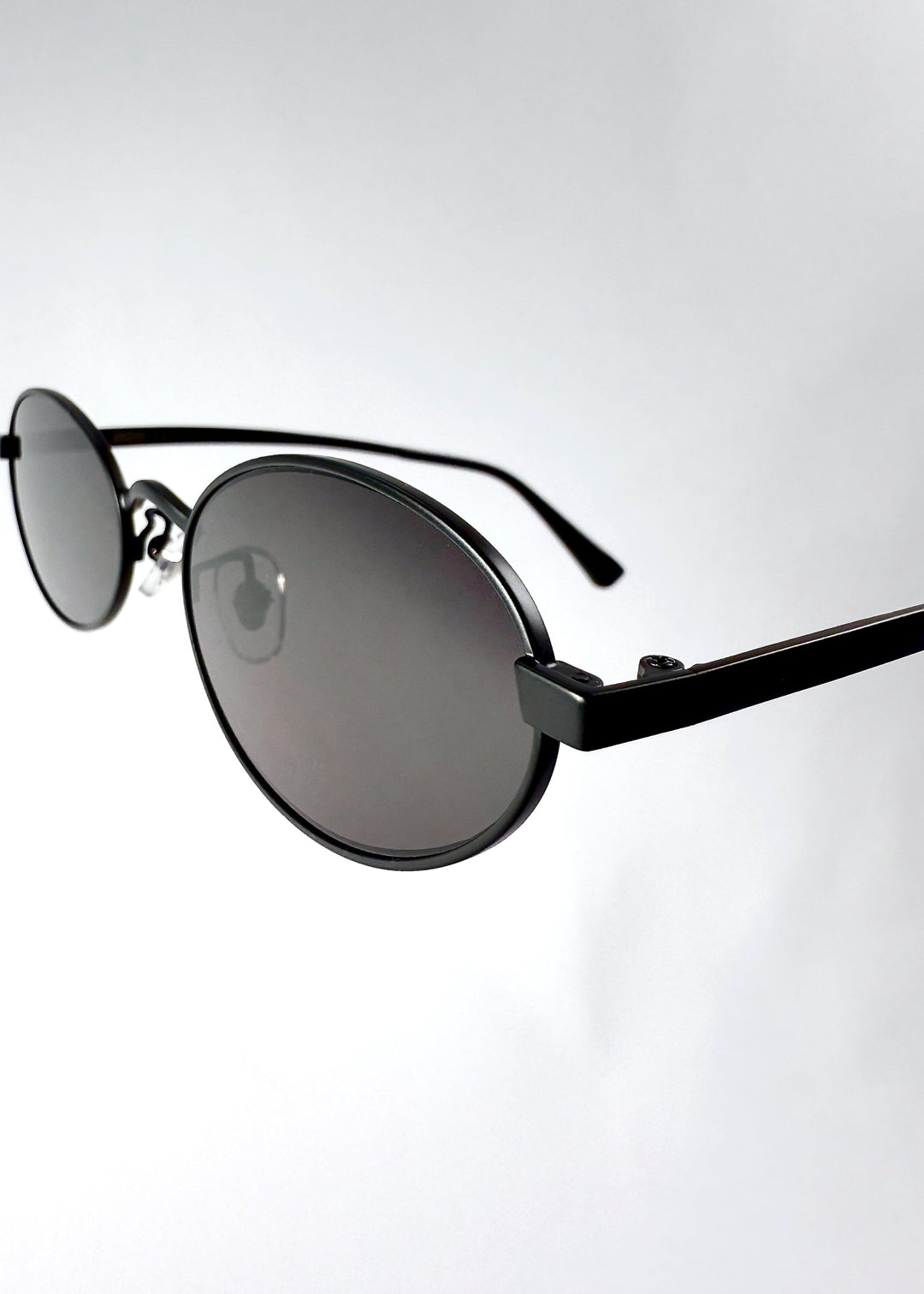 Detail shot of the satin black stainless steel frame of Solstice – Shadow Black, emphasizing craftsmanship and polish. 