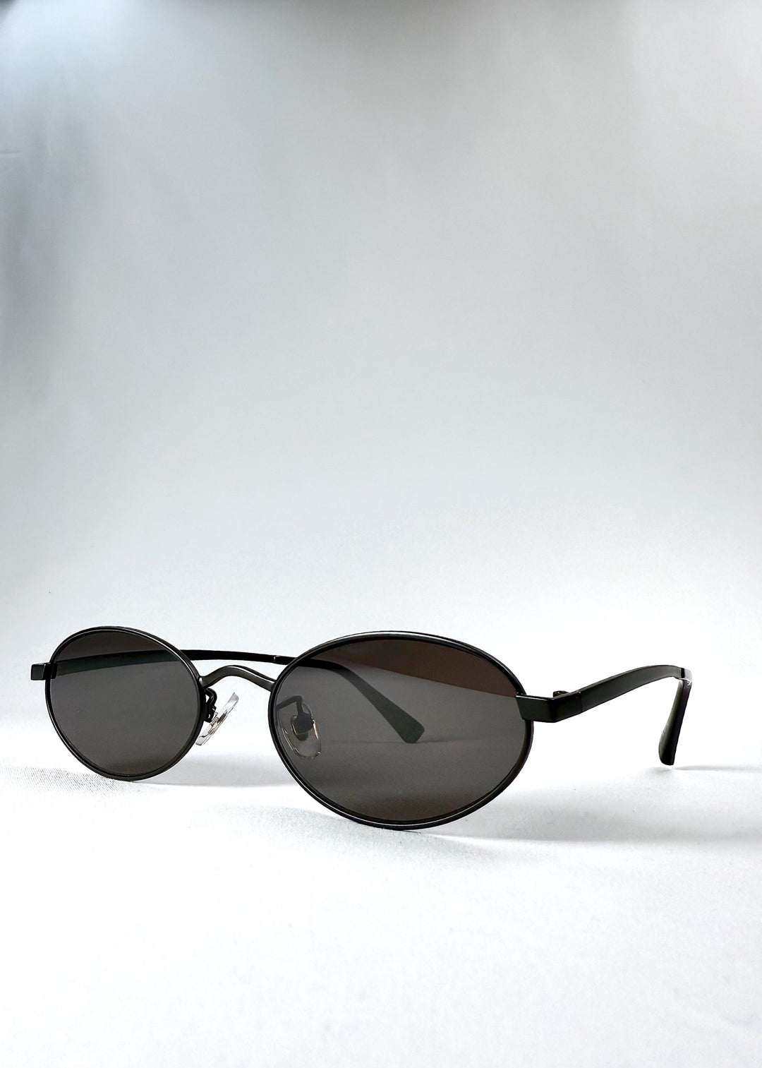 Front-angle view of Solstice – Shadow Black, revealing the satin black oval frame and balanced silhouette. 