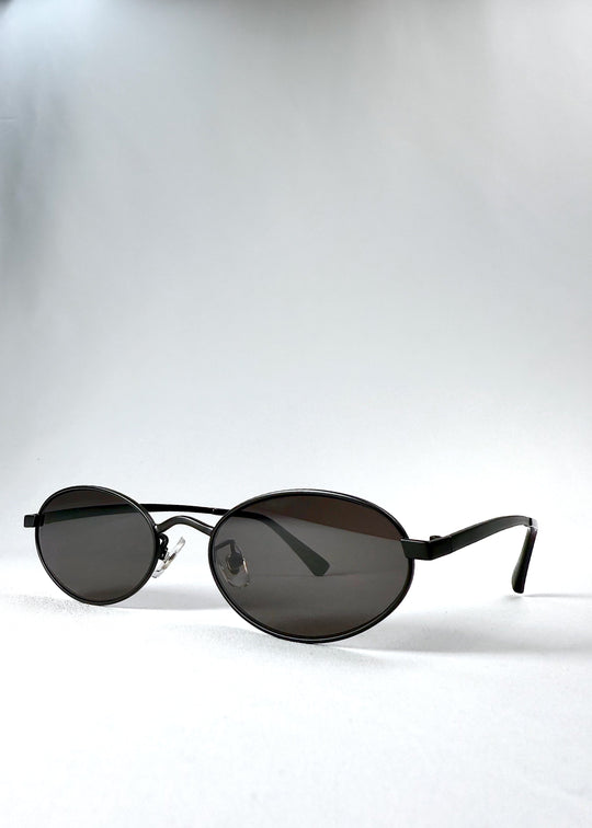 Front-angle view of Solstice – Shadow Black, revealing the satin black oval frame and balanced silhouette. 