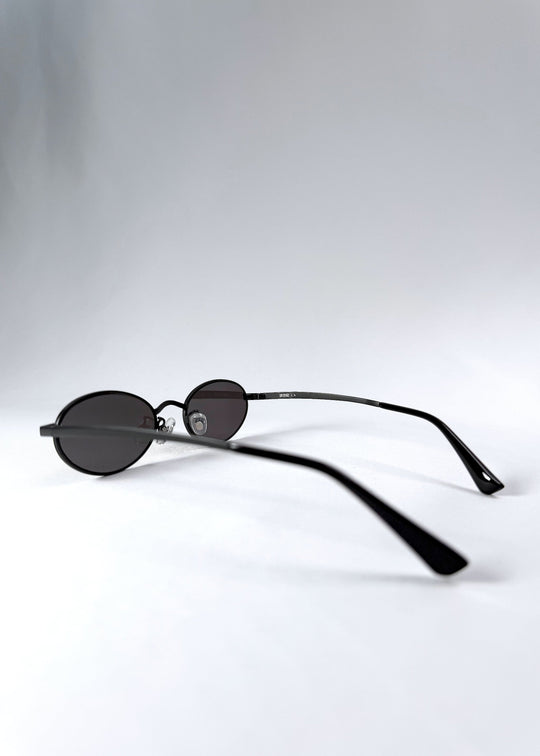 Side profile of Solstice – Shadow Black sunglasses, highlighting the slim black temples and minimal hinge design. 