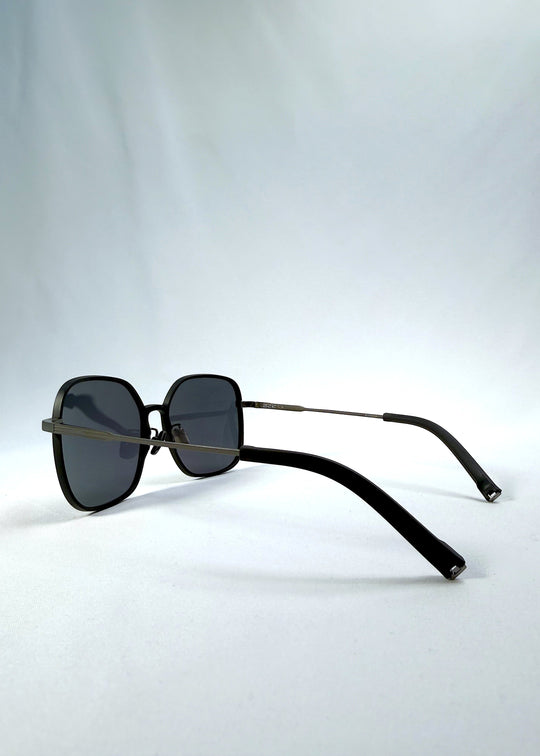 Side-angle view of Spica sunglasses in Black, featuring an ultra-light frame with titanium temples and polarized lenses, showing the lens shape and temple profile. 