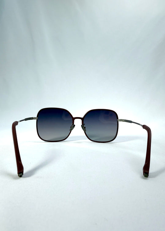 Back view of Spica sunglasses in Cherry Red, featuring an ultra-light frame with titanium temples and polarized lenses, showing the inside frame and open temples. 