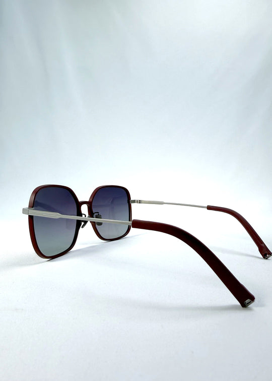 Side-angle view of Spica sunglasses in Cherry Red, featuring an ultra-light frame with titanium temples and polarized lenses, showing the lens shape and temple profile. 