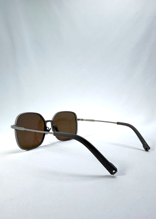 Side-angle view of Spica sunglasses in Milk Tea Brown, featuring an ultra-light frame with titanium temples and polarized lenses, showing the lens shape and temple profile. 