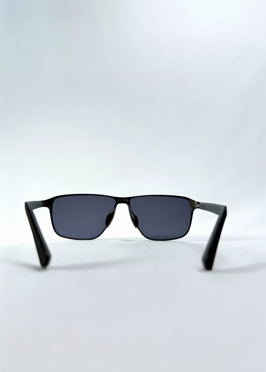Back view of Vector Line sunglasses in Matte Black, featuring wide matte black rectangular metal frame and full grey polarized lenses, showing the inside frame and open temples.