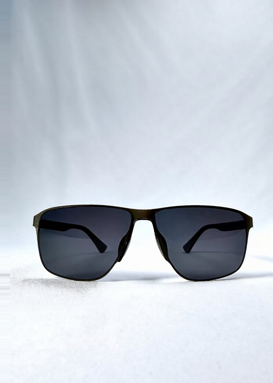 Front view of Vector Line sunglasses in Matte Black, featuring wide matte black rectangular metal frame and full grey polarized lenses, showing the full front silhouette.