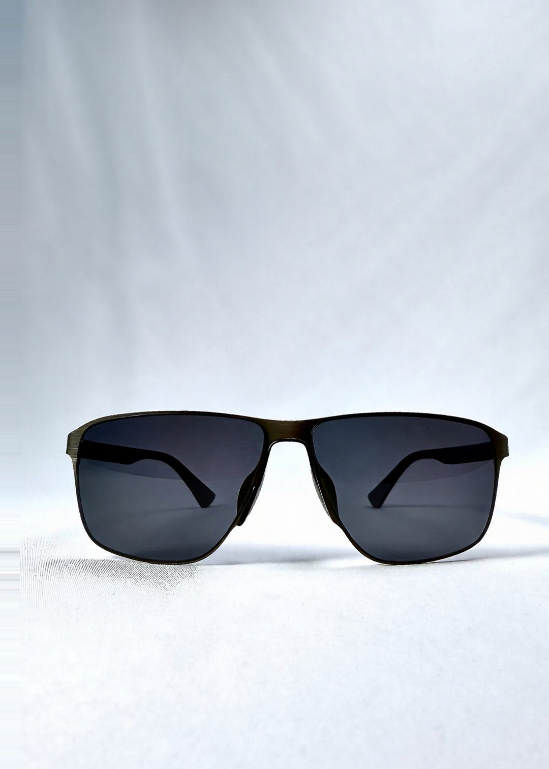 Front view of Vector Line sunglasses in Matte Black, featuring wide matte black rectangular metal frame and full grey polarized lenses, showing the full front silhouette. 