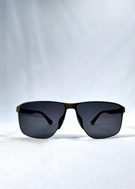 Front view of Vector Line sunglasses in Matte Black, featuring wide matte black rectangular metal frame and full grey polarized lenses, showing the full front silhouette. 