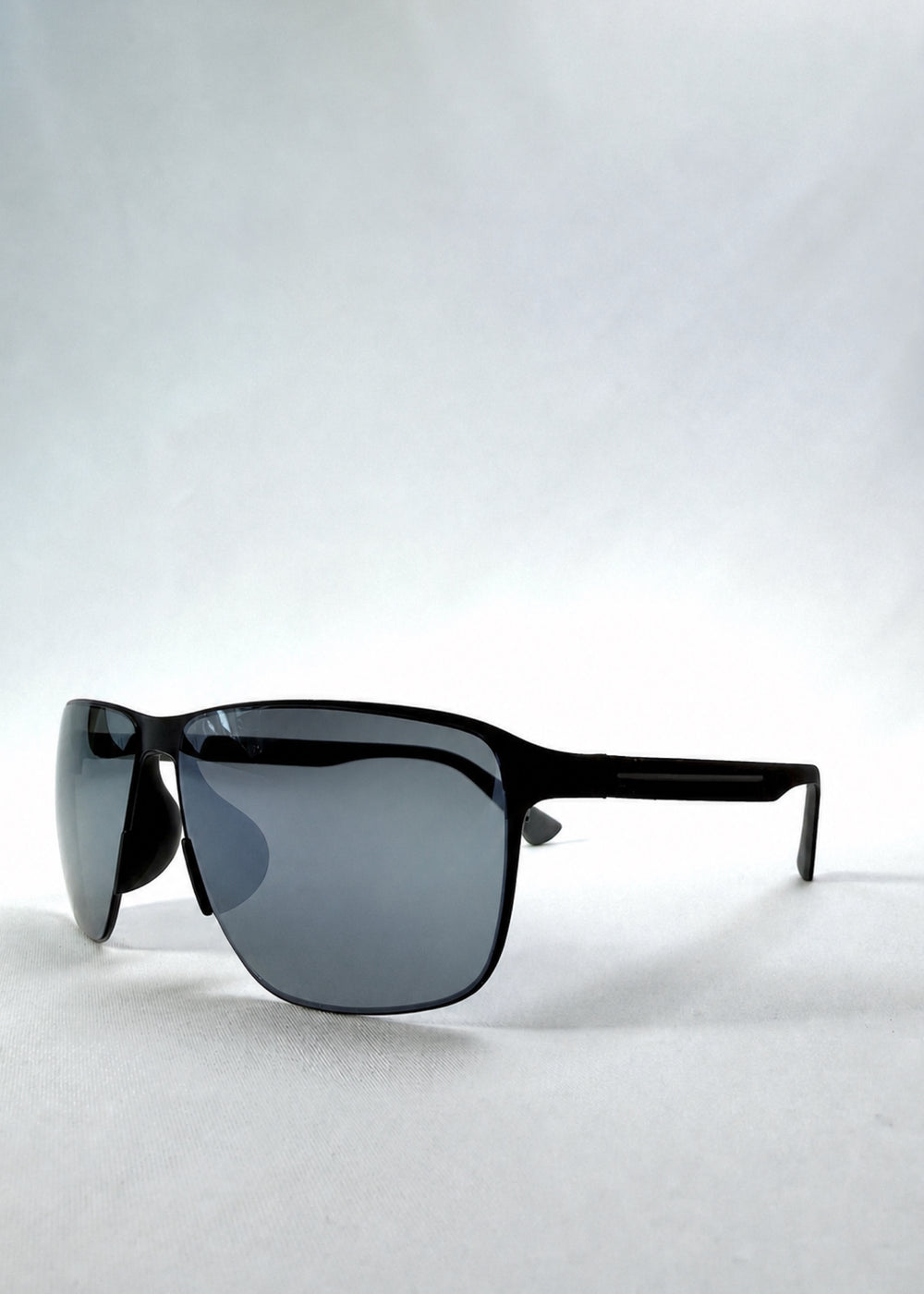 Three-quarter front view of Vector Line sunglasses in Mercury Shadow, featuring wide black metal frame and silver mirrored polarized lenses, showing the front shape and temple profile.