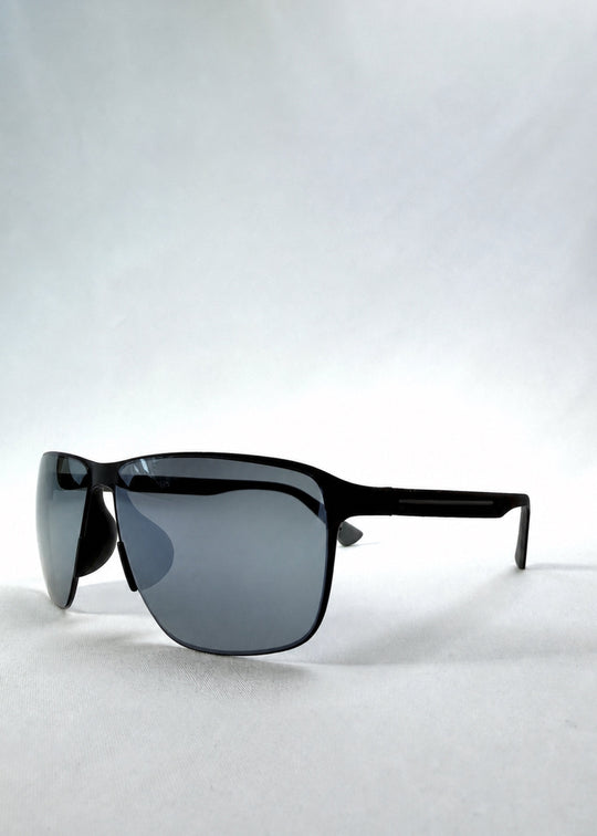 Three-quarter front view of Vector Line sunglasses in Mercury Shadow, featuring wide black metal frame and silver mirrored polarized lenses, showing the front shape and temple profile. 
