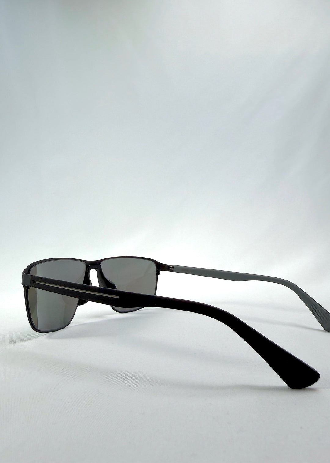 Side view of Vector Line sunglasses in Mercury Shadow, featuring wide black metal frame and silver mirrored polarized lenses, showing the lens shape and temple profile. 