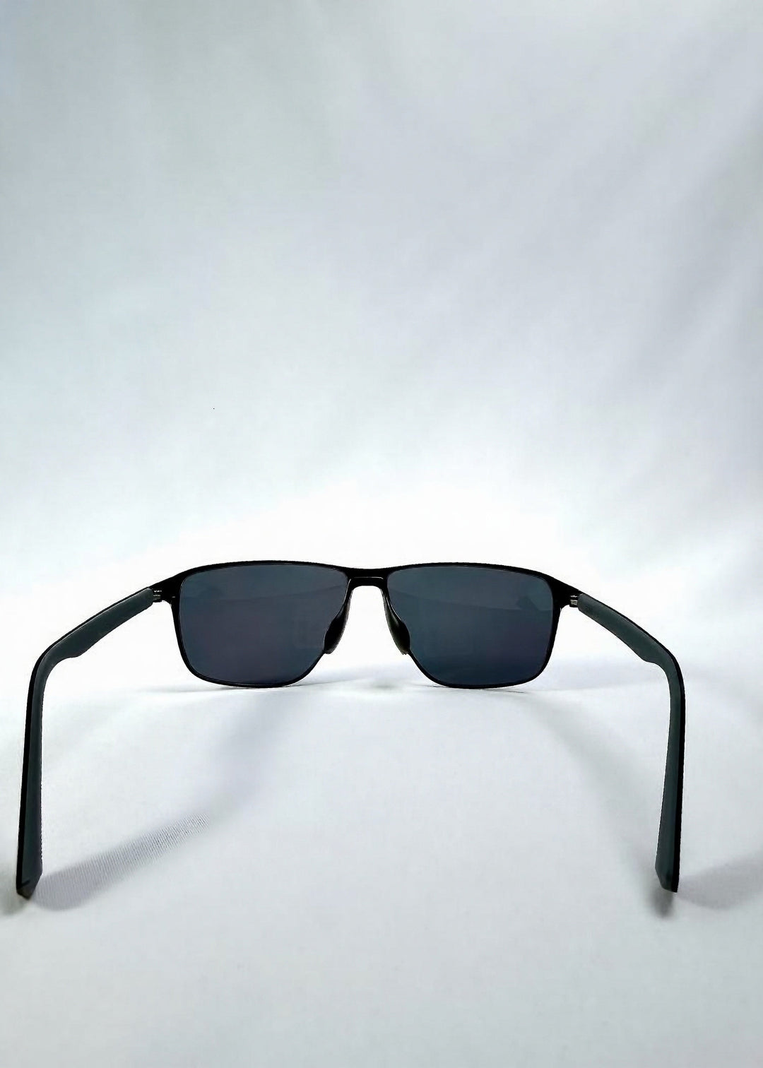 Back view of Vector Line sunglasses in Violet Graphite, featuring wide gunmetal frame and violet-grey polarized lenses, showing the inside frame and open temples. 