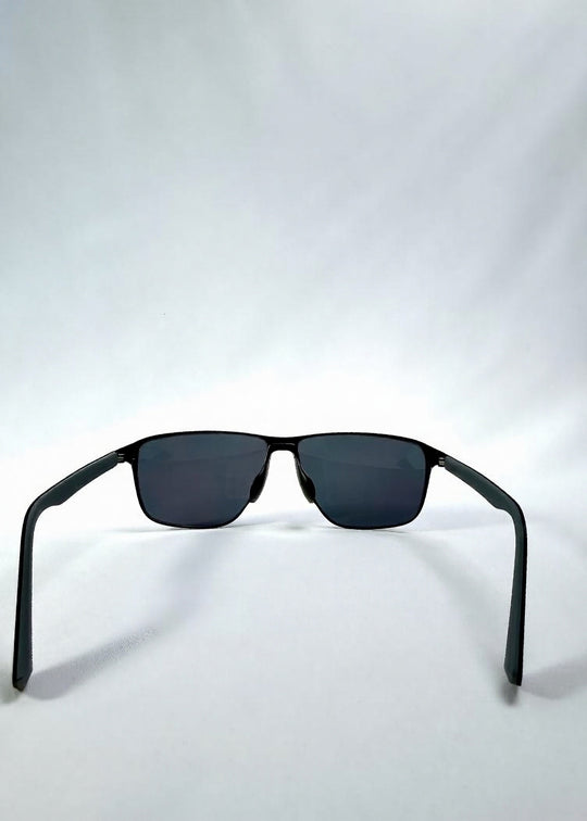 Back view of Vector Line sunglasses in Violet Graphite, featuring wide gunmetal frame and violet-grey polarized lenses, showing the inside frame and open temples. 
