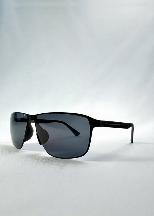 Three-quarter front view of Vector Line sunglasses in Violet Graphite, featuring wide gunmetal frame and violet-grey polarized lenses, showing the front shape and temple profile. 