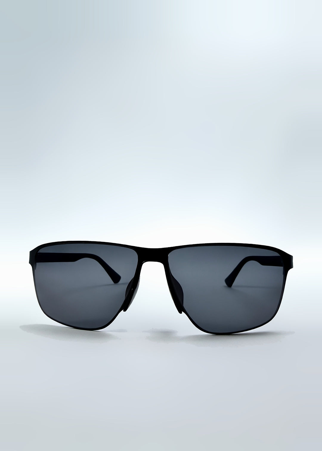Front view of Vector Line sunglasses in Violet Graphite, featuring wide gunmetal frame and violet-grey polarized lenses, showing the full front silhouette. 