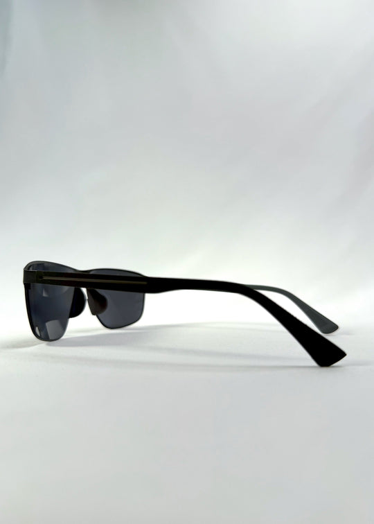 Side view of Vector Line sunglasses in Violet Graphite, featuring wide gunmetal frame and violet-grey polarized lenses, showing the lens shape and temple profile. 