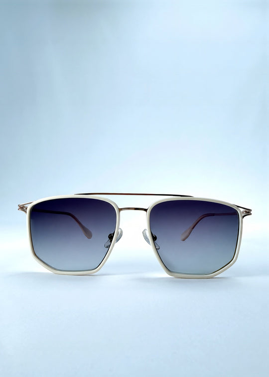 Front view of AZE Vela Trace sunglasses in Glacial Smoke, featuring a pale gold-tone rectangular frame and blue-gray gradient lenses, showing the full front silhouette. 