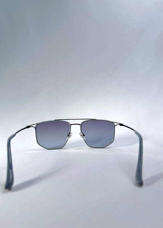Back view of AZE Vela Trace sunglasses in Midnight Blue, featuring a gray-blue rectangular frame and blue-gray gradient lenses, showing the inner frame and open temples.