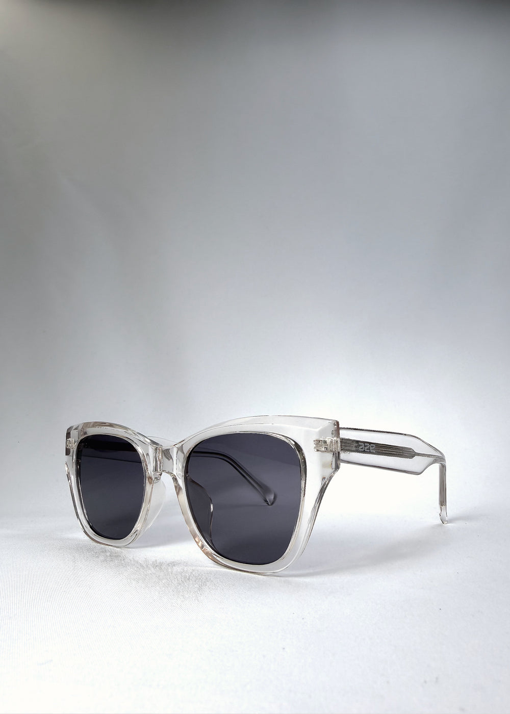 Front angle view of the Veyron sunglasses in Crystal Static, highlighting the sharp, crystalline edges and modern contrast of the slate-blue lenses.