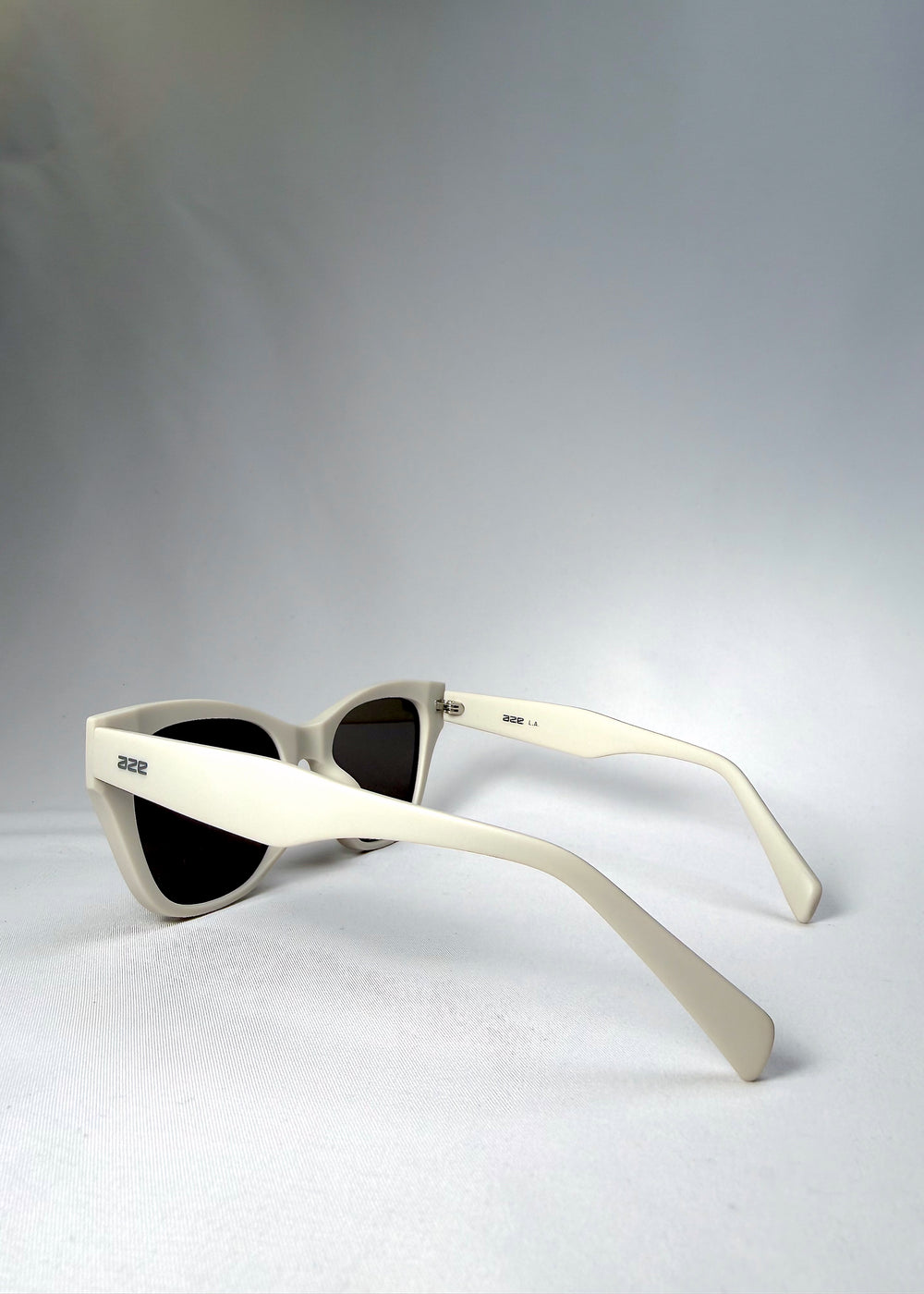Angled back view of Veyron sunglasses in Pale Mirage, highlighting sculpted temples and upswept brow line in matte grey acetate.