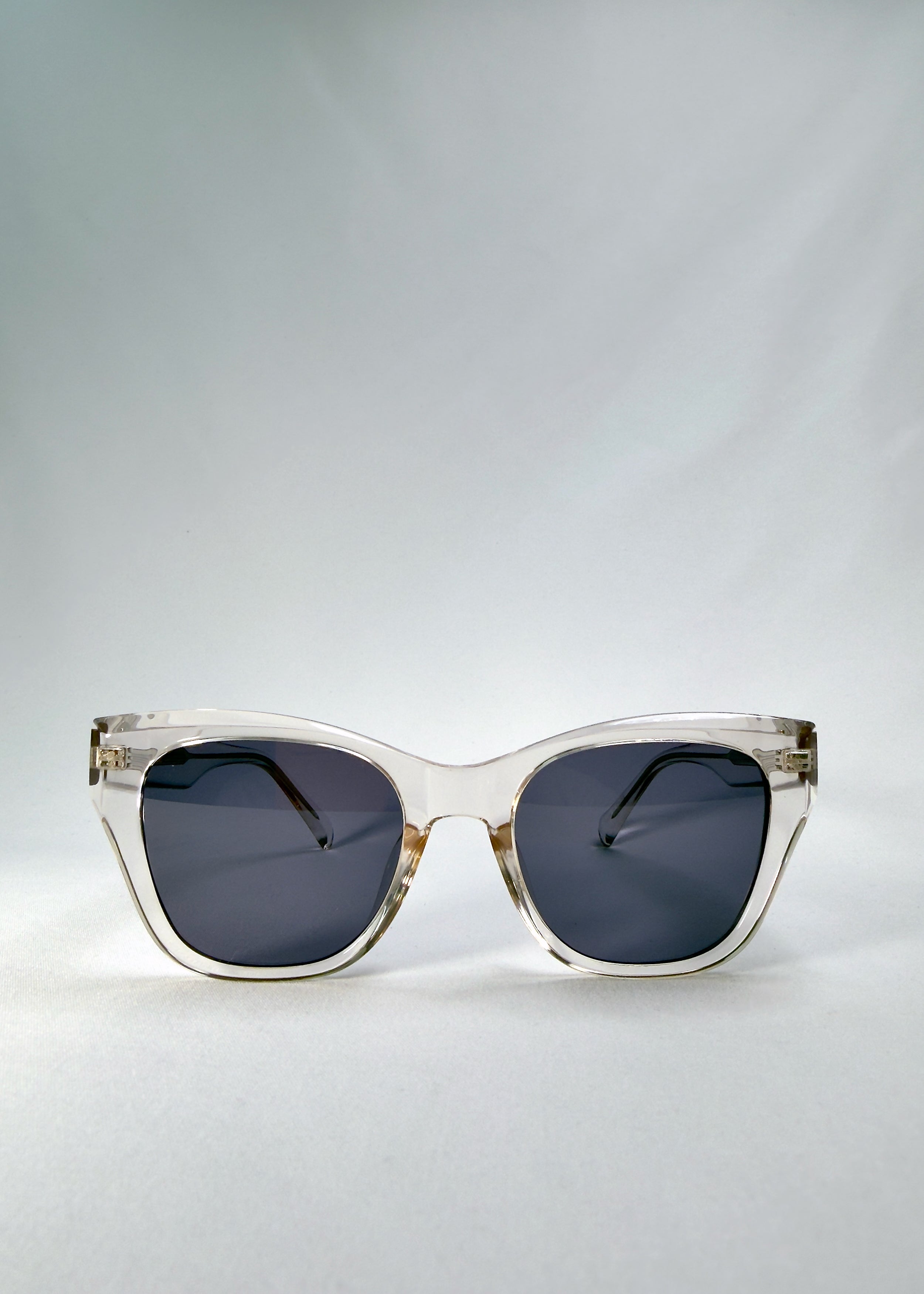 Front view of Veyron sunglasses in Crystal Static showing transparent acetate frame and dark grey lenses.