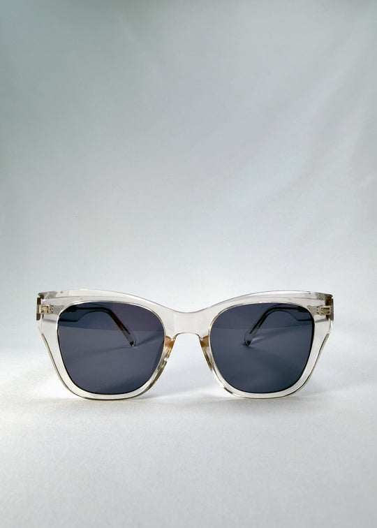 Front view of Veyron in Crystal Static, showing the clear acetate cat-eye frame and slate blue lenses. 