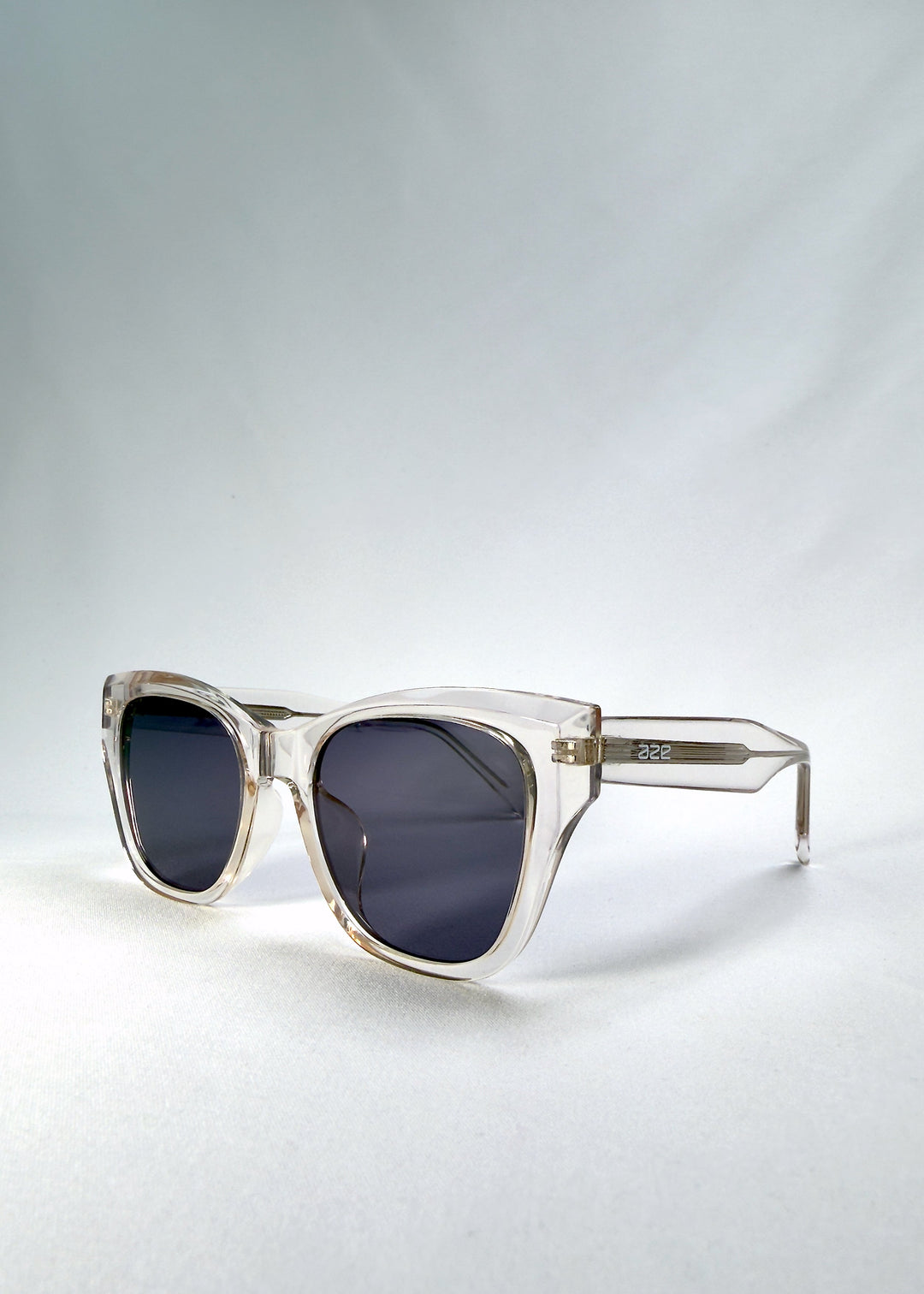 Left front-angle view of Veyron in Crystal Static, highlighting the clear acetate frame and sharp cat-eye silhouette. 