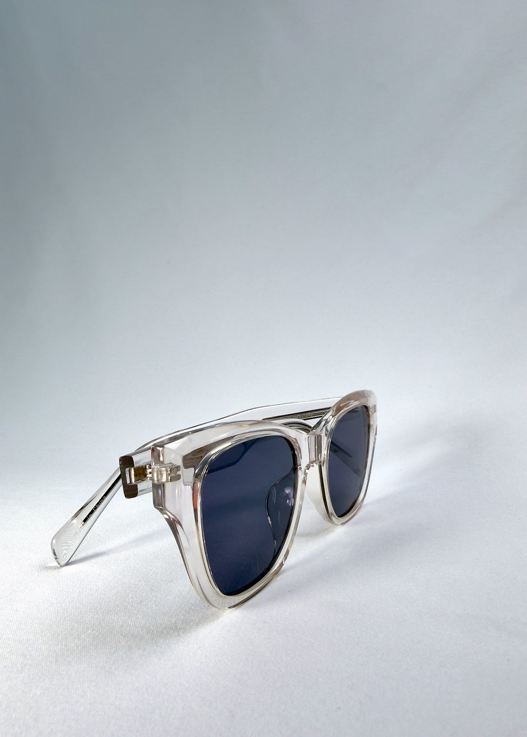 Right front-angle view of Veyron in Crystal Static, showing the clear frame edges and slate blue lenses. 