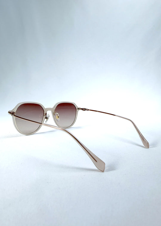 Back-angle view of AZE Vireo Arc sunglasses in Roselight, featuring a translucent ivory frame and soft rose gradient lenses, showing the rear frame structure and temple alignment.