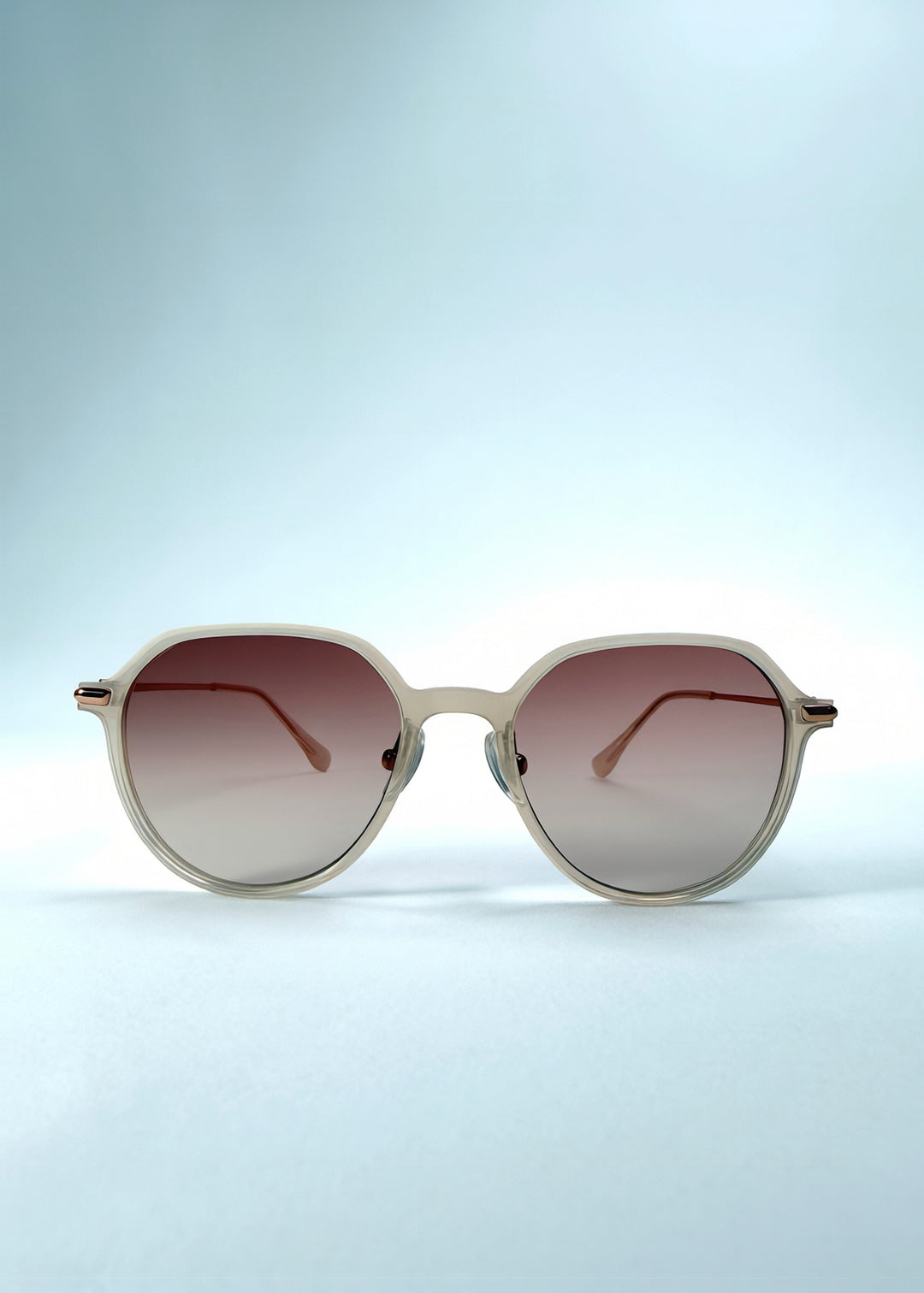 Front view of AZE Vireo Arc sunglasses in Roselight, featuring a translucent ivory frame and soft rose gradient lenses, showing the full front silhouette.