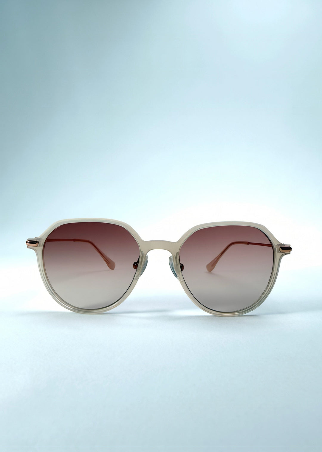 Front view of AZE Vireo Arc sunglasses in Roselight, featuring a translucent ivory frame and soft rose gradient lenses, showing the full front silhouette. 