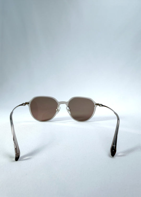 Back view of AZE Vireo Arc sunglasses in Taupe Rosé, featuring a translucent taupe frame and rose-brown gradient lenses, showing the inner frame and open temples.