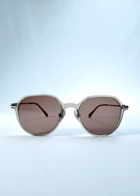 Front view of AZE Vireo Arc sunglasses in Taupe Rosé, featuring a translucent taupe frame and rose-brown gradient lenses, showing the full front silhouette. 