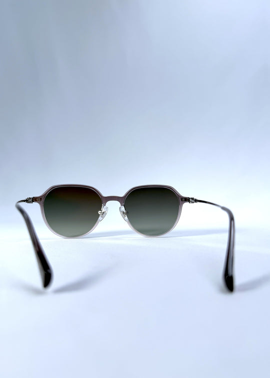 Back view of AZE Vireo Arc sunglasses in Verdant Halo, featuring a translucent smoky mauve frame and green gradient lenses, showing the inner frame and open temples.