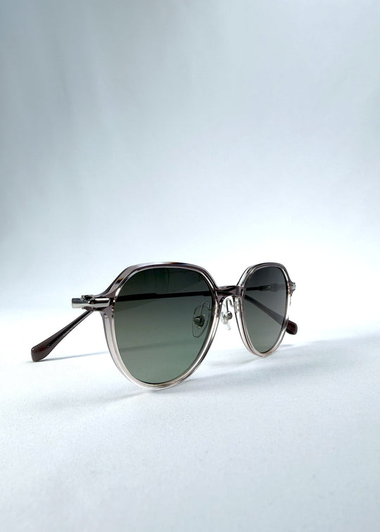 Folded view of AZE Vireo Arc sunglasses in Verdant Halo, featuring a translucent smoky mauve frame and green gradient lenses, showing the folded temples and frame profile. 