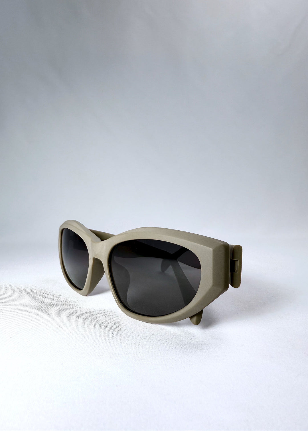 Close-up of the matte bronze frame and dark polarized lenses of Void Striker sunglasses. 