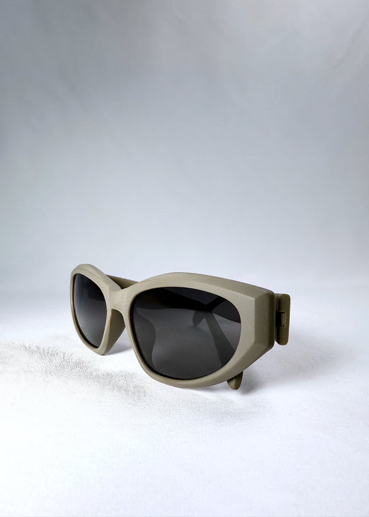 Close-up of the matte bronze frame and dark polarized lenses of Void Striker sunglasses. 