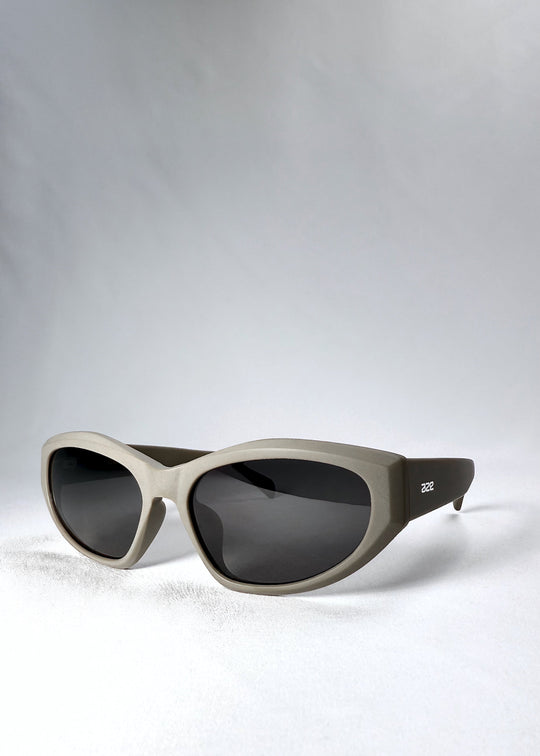 Front angle view showing the bold geometric curves and matte bronze finish of the Void Striker sunglasses. 