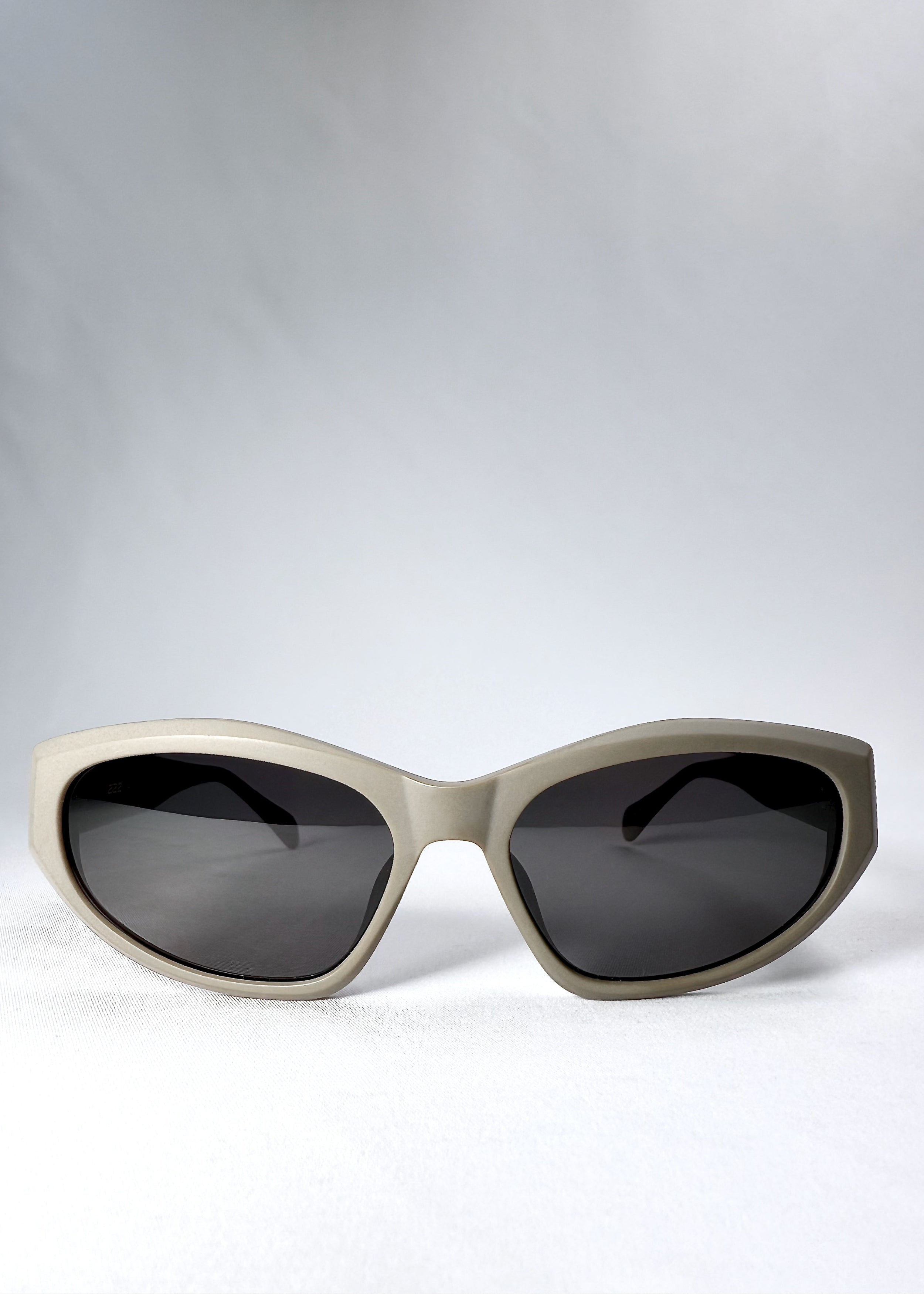 Front view of Void Striker sunglasses in Bronze Mirage with angular cat-eye silhouette and smoke lenses.