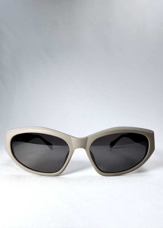 Front view of Void Striker sunglasses in Bronze Mirage with angular cat-eye silhouette and smoke lenses. 