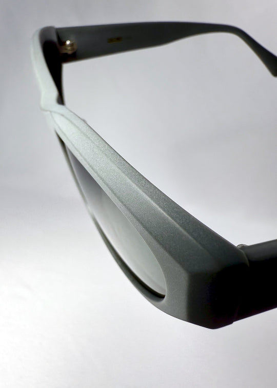 Detail shot of the geometric acetate frame edge and matte finish on the Void Striker sunglasses.