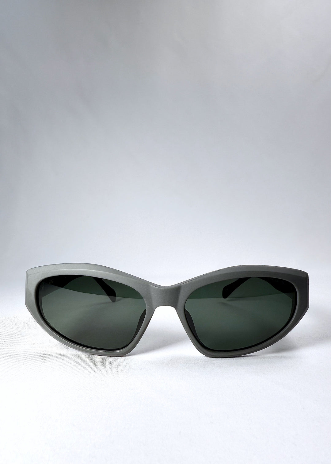 Front view of Void Striker sunglasses in Carbon Ash with matte charcoal acetate frame and dark grey polarized lenses.