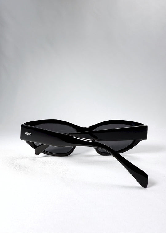 Folded view of Void Striker sunglasses in Obsidian Black showing compact shape and layered acetate build. 